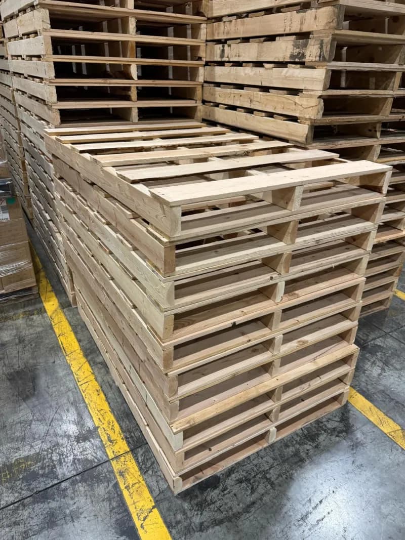 Pallets stacked in warehouse with yellow floor